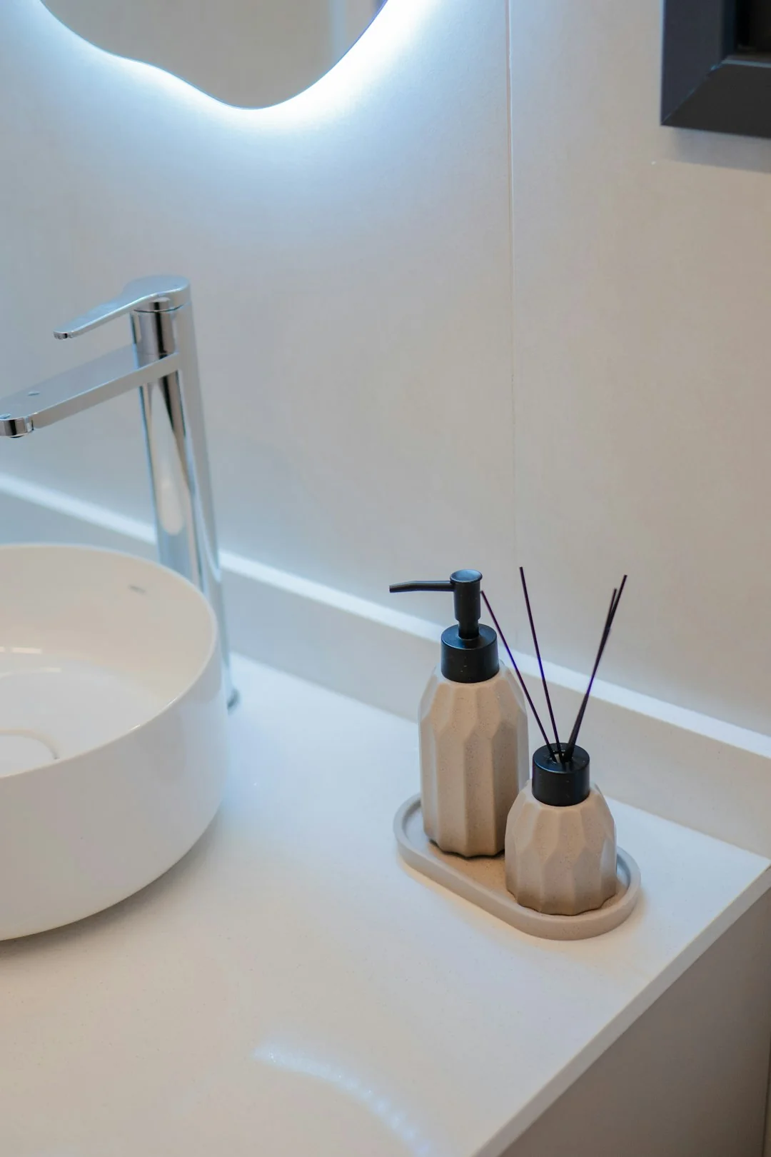 Anonymous person in yellow rubber gloves using simple sponge for cleaning mirror in bathroom